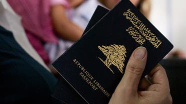 A Lebanese woman holds her passport at Damascus Airport July 16, 2006. (File photo: Reuters)