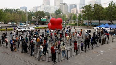 People line up at a makeshift nucleic acid testing site near the Central Business District (CBD) amid the coronavirus disease (COVID-19) outbreak, in Chaoyang district of Beijing, China April 29, 2022. (Reuters)