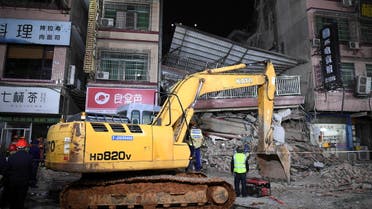 Rescuers work next to an excavator at a site where a building collapsed in Changsha, Hunan province, China April 29, 2022. Picture taken April 29, 2022. cnsphoto via REUTERS ATTENTION EDITORS - THIS IMAGE WAS PROVIDED BY A THIRD PARTY. CHINA OUT.