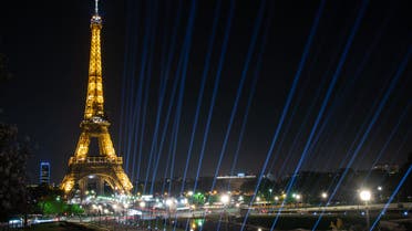 A picture taken at night on April 26, 2022 shows a view of the illuminated Eiffel Tower. (Photo by AFP)