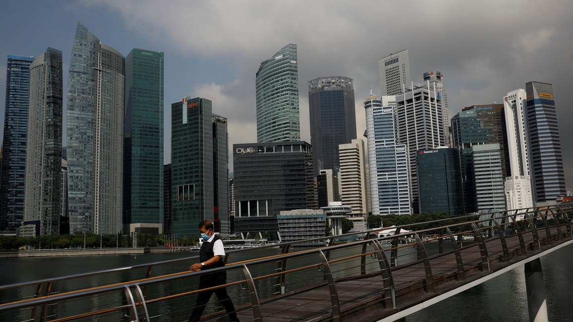 A man passes the city skyline during the coronavirus disease (COVID-19) outbreak, in Singapore, September 29, 2021. (Reuters)