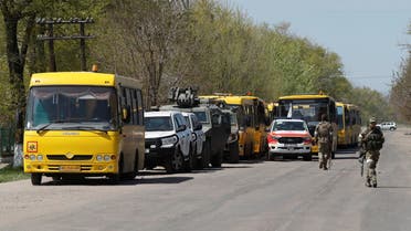 Buses to transport evacuees, including civilians who left the area near Azovstal steel plant in Mariupol, are seen near a temporary accommodation centre during Ukraine-Russia conflict in the village of Bezimenne in the Donetsk Region, Ukraine May 1, 2022. REUTERS/Alexander Ermochenko