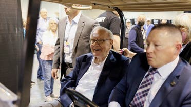 Berkshire Hathaway CEO Warren Buffett rides on a golf cart through the exhibition hall as investors and guests arrive for the first in-person annual meeting since 2019 of Berkshire Hathaway Inc in Omaha, Nebraska, US, on April 29, 2022. (Reuters)