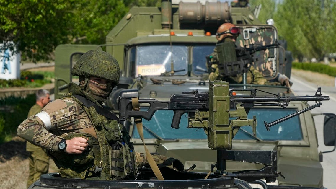 Armed Russian servicemen stand atop their military vehicles near the Zaporizhzhia Nuclear Power Station, the largest nuclear power plant in Europe and among the 10 largest in the world, in Enerhodar, Zaporizhzhia region, in territory under Russian military control, southeastern Ukraine, Sunday, May 1, 2022. (AP Photo)