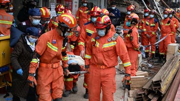 Rescue workers carry an injured person on a stretcher at a site where a building collapsed in Changsha, Hunan province, China May 1, 2022. (Reuters)