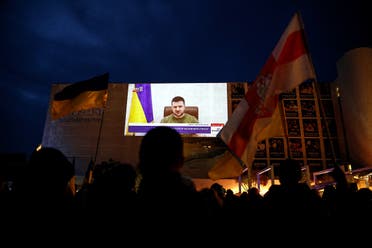 Demonstrators gather in support of Ukraine following Russia’s invasion and watch Ukrainian President Volodymyr Zelenskyy's speech as it is broadcasted to the Knesset, Israel’s parliament, at Habima Square in Tel Aviv, Israel, on March 20, 2022. (Reuters)