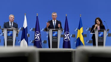 NATO Secretary General Jens Stoltenberg (C), Finland Ministers for Foreign Affairs Pekka Haavisto (L) and Sweden Foreign minister Ann Linde (R) give a press conference after their meeting at the Nato headquarters in Brussels on January 24, 2022. (Photo by JOHN THYS / AFP)