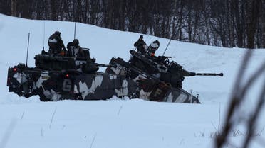 Swedish army members drive infantry fighting vehicles as part of military exercise called Cold Response 2022, gathering around 30,000 troops from NATO member countries plus Finland and Sweden, amid Russia's invasion of Ukraine, in Setermoen in the Artic Circle, Norway, March 25 2022. REUTERS/Yves Herman