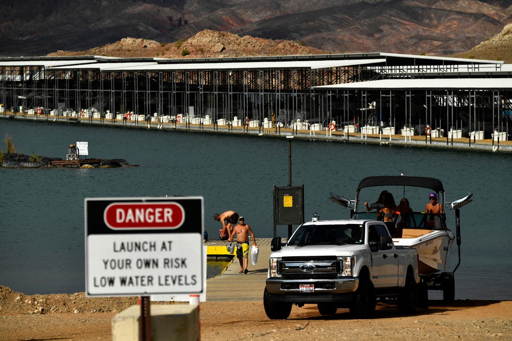 In this file photo taken on July 19, 2021 visitors remove a boat from a boat ramp near the Lake Mead Marina during low water levels due to the western drought at Lake Mead on the Colorado River in Boulder City, Nevada. (AFP)