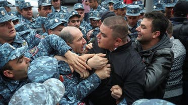 Police officers restrain participants of an anti-government demonstration in Yerevan, Armenia on May 3, 2022. (Reuters)