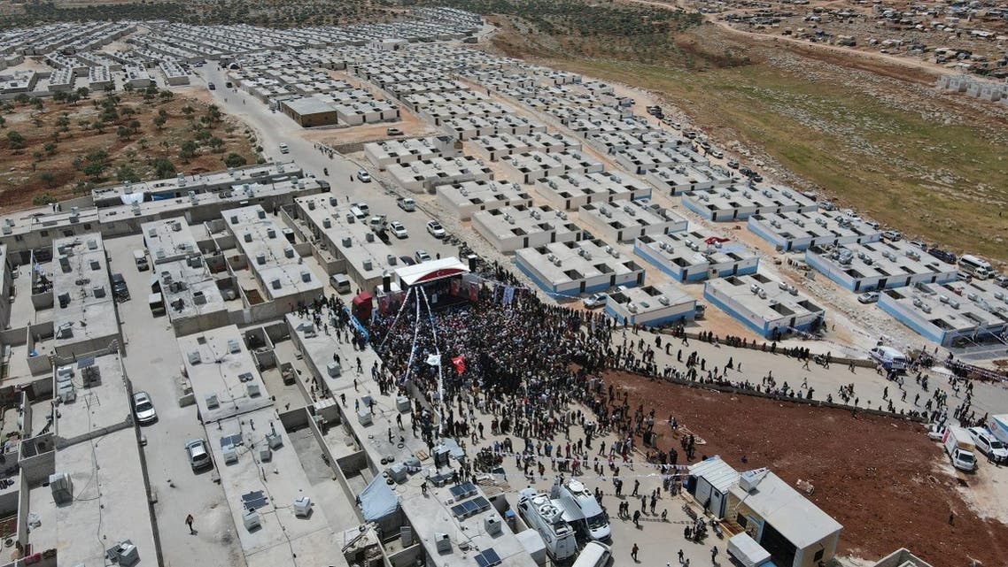 An aerial picture shows the crowd as Turkish Minister of Interior Süleyman Soylu inaugurates a housing complex for internally displaced Syrians built with Turkey’s support, at the Kammouneh camps near the town of Sarmada in Syria’s northwestern Idlib province, on May 3, 2022. (AFP)