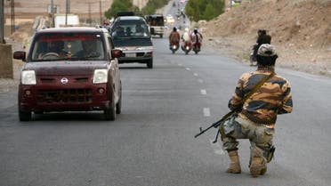 A Taliban fighter kneels down while on guard at a road checkpoint in Kandahar on April 23, 2022. (File photo: AFP)