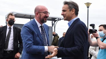 Greek Prime Minister Kyriakos Mitsotakis speaks with the European Council President Charles Michel during an event for the commencement of the realisation of a floating storage and regasification unit (FSRU), in Alexandroupolis, Greece on May 3, 2022. (Reuters)