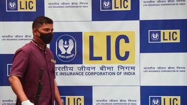 A man walks past a hoarding of Life Insurance Corporation of India (LIC) after the press conference of the LIC initial public offering (IPO) launch in Mumbai, India, April 27, 2022. (Reuters)