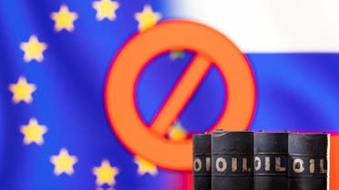 Models of oil barrels are seen in front of the displayed sign stop, EU and Russia flag colors in this illustration taken March 8, 2022. (File Photo: Reuters)
