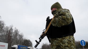 A member of the Ukrainian State Border Guard Service keeps watch at the Senkivka checkpoint near the border with Belarus and Russia in the Chernihiv region, Ukraine February 16, 2022. (Reuters)