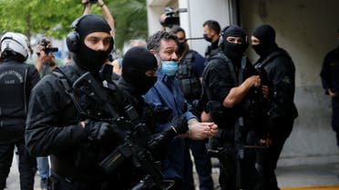 Ioannis Lagos, Greek member of the European Parliament and former member of extreme right Golden Dawn party, is escorted by anti-terrorism police officers to the prosecutor's office in Athens, Greece May 15, 2021. (File photo: Reuters)