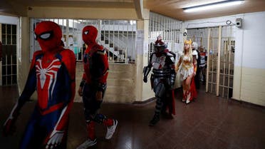 Argentine volunteers and members of the so-called Hero Club (Club de Heroes), who impersonate Spiderman, The Mandalorian, and She-Ra, walk into the 33rd prison in Los Hornos as part of a wider program for vulnerable minors, on the outskirts of Buenos Aires, Argentina April 30, 2022. (Reuters)