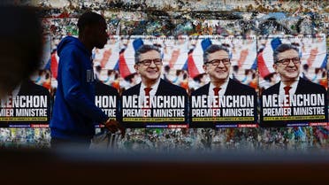 A man walks past by posters of the parliamentary election of Jean-Luc Melenchon, leader of the far-left opposition party La France Insoumise (France Unbowed - LFI) in Paris, France May 3, 2022. Poster reads “Melenchon Prime Minister.” (Reuters)