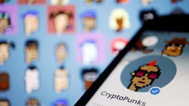 The CryptoPunks page on Opensea app is displayed next to non-fungible tokens (NFTs) of the CryptoPunks collection by Larva Labs shown on its website, in this illustration picture taken on March 25, 2022. (Reuters)