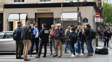 Police and investigators gather at the entrance to a Chanel shop on Place Vendome in Paris, on May 5, 2022, after a suspected armed robbery. (AFP)