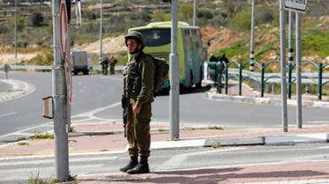 A member of the Israeli forces stands guard at the scene of a stabbing attack at the Gush Etzion settlement bloc, near Bethlehem, in the Israeli-occupied West Bank March 31, 2022. REUTERS/Mussa Qawasma