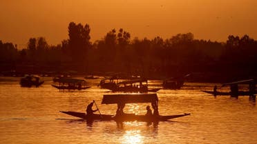 Tourists ride Shikaras or boats in the waters of Dal Lake during sunset in Srinagar, on April 5, 2022. (Reuters)