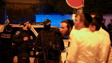 Local residents and Israeli security personnel gather in the area where at least three people were killed in what police suspect was a Palestinian attack, on Israeli Independence Day, in Elad, Israel, on May 6, 2022. (Reuters)