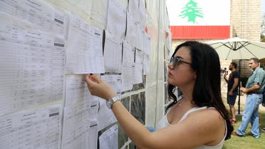 A Lebanese expat checks her name on the list before casting her vote at the Lebanese Consulate in Dubai, United Arab Emirates April 27, 2018. REUTERS/Satish Kumar