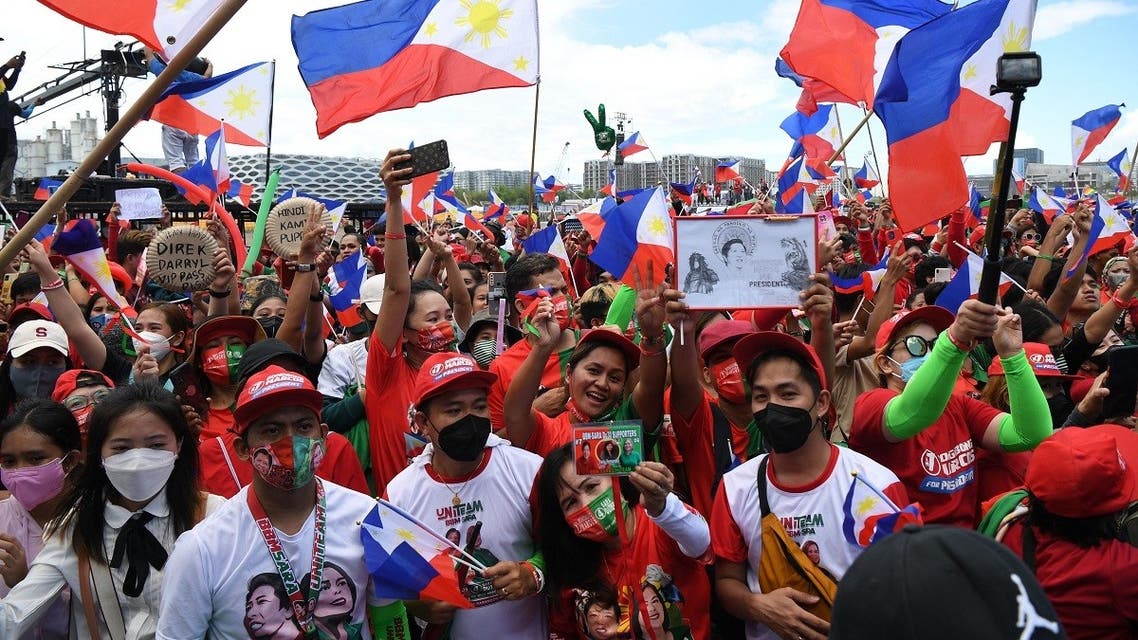 Supporters of presidential candidate Ferdinand Marcos Jr., son of the late dictator Ferdinand Marcos, flash the V sign in Paranaque City, suburban Manila on May 7, 2022, days ahead of the May 9 presidential election. (AFP)