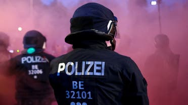 Police officers gather amid coloured smoke during a May Day protest in Berlin, Germany, May 1, 2022. (File photo: Reuters)