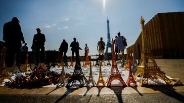 Tourists walk at Trocadero square near the Eiffel Tower and miniatures of it on a warm and sunny day in Paris, France, September 3, 2021. REUTERS/Eric Gaillard
