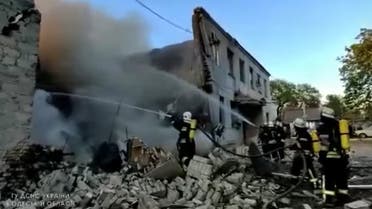Firefighters spray water onto fire in a destroyed building after a missile strike, in Odessa, Ukraine, as seen in this still image taken from a handout video released on May 2, 2022. (Reuters)