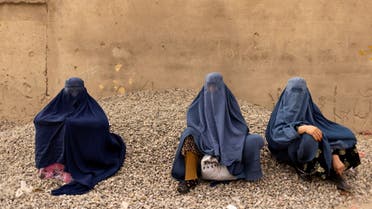 Women wearing burqas pause at the side of a road in Kabul, Afghanistan October 26, 2021. Picture taken October 26, 2021. REUTERS/Jorge Silva TPX IMAGES OF THE DAY