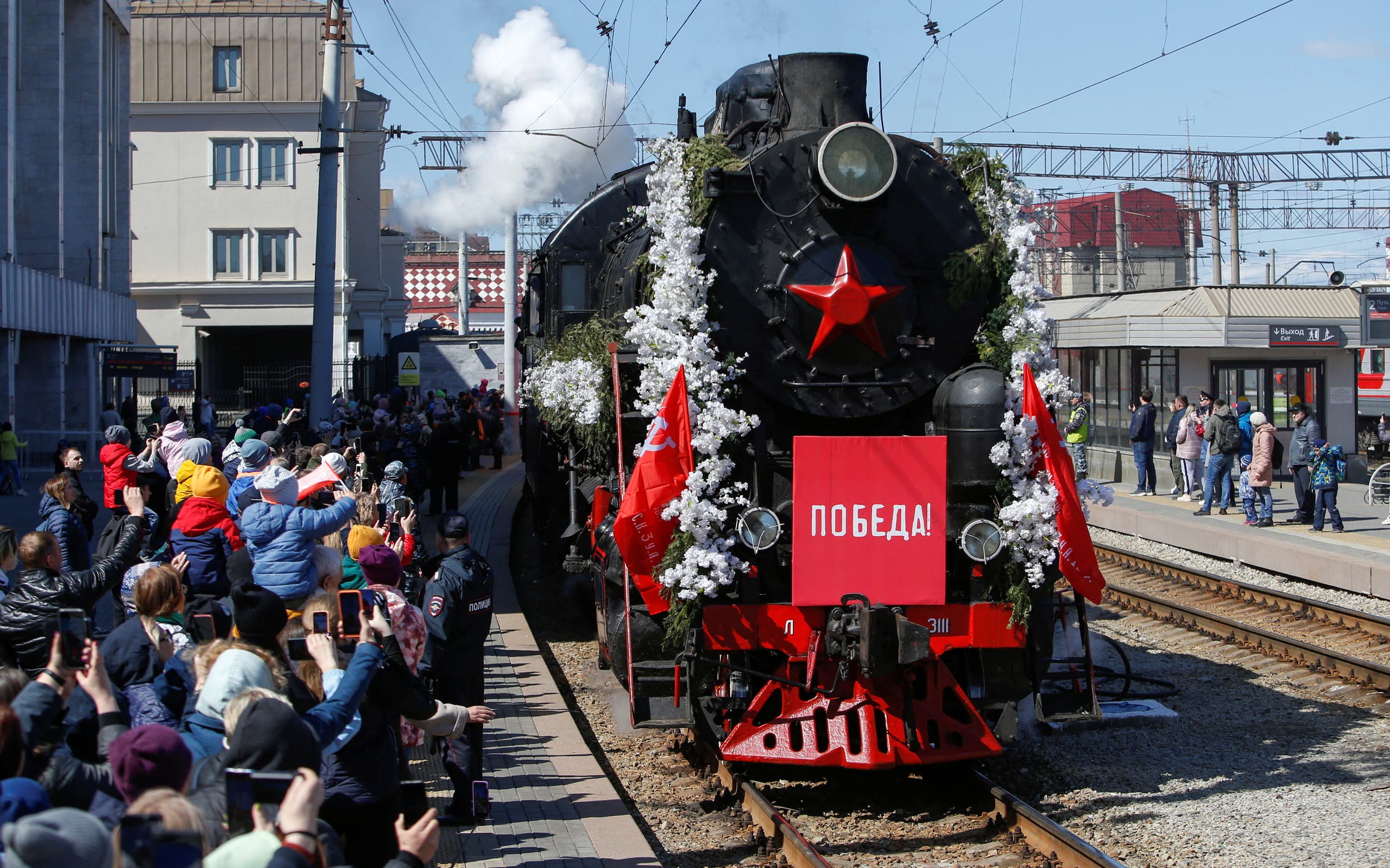 A Soviet-era train arrives at a railway station ahead of Victory Day, which marks the anniversary of the victory over Nazi Germany in World War Two, in Yekaterinburg, Russia May 7, 2022. A sign on a train reads: Victory. (Reuters)