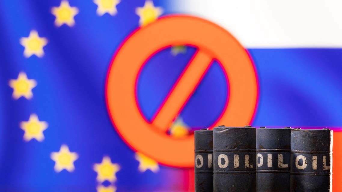 Models of oil barrels are seen in front of the displayed sign stop, EU and Russia flag colours in this illustration taken March 8, 2022. (Reuters)