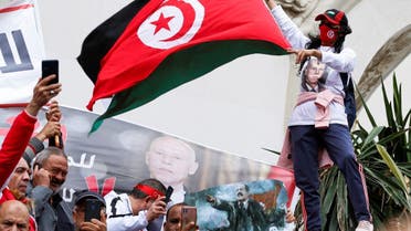 A woman waves a flag during a rally in support of Tunisian President Kais Saied in Tunis, Tunisia, on May 8, 2022. (Reuters)