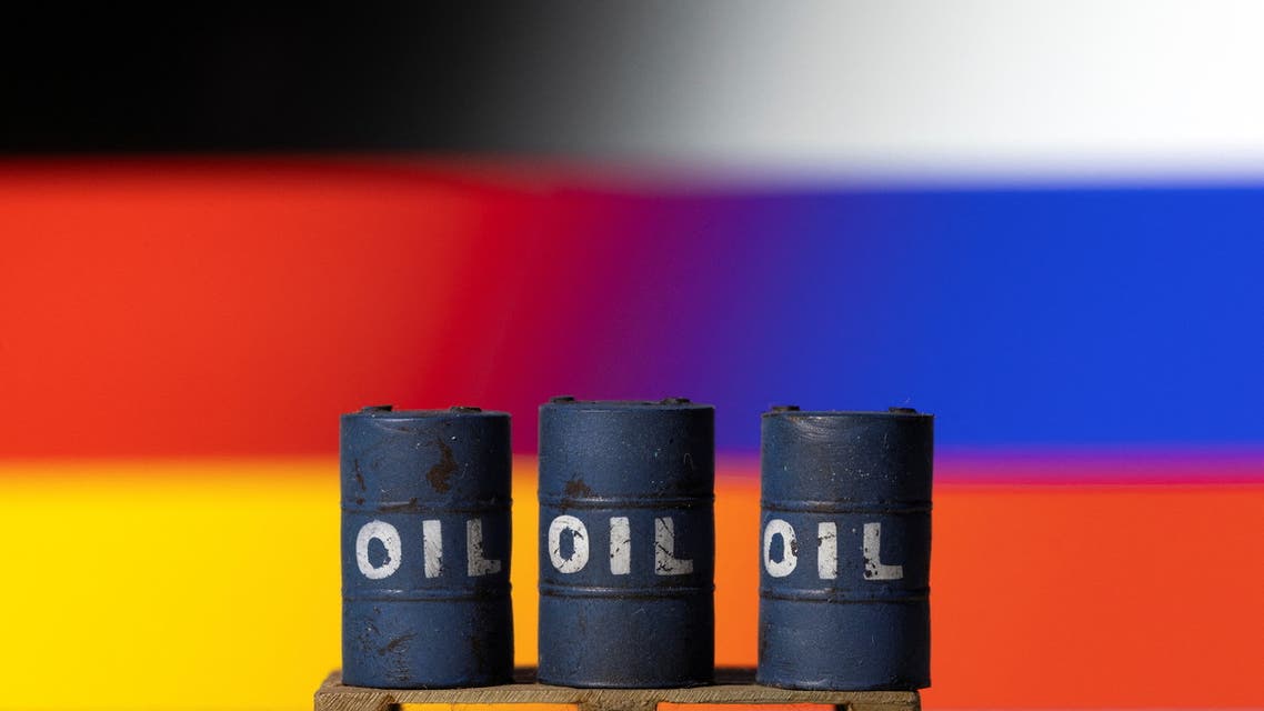 Models of oil barrels are seen in front of German and Russian flags in this illustration taken, April 20, 2022. (Reuters)
