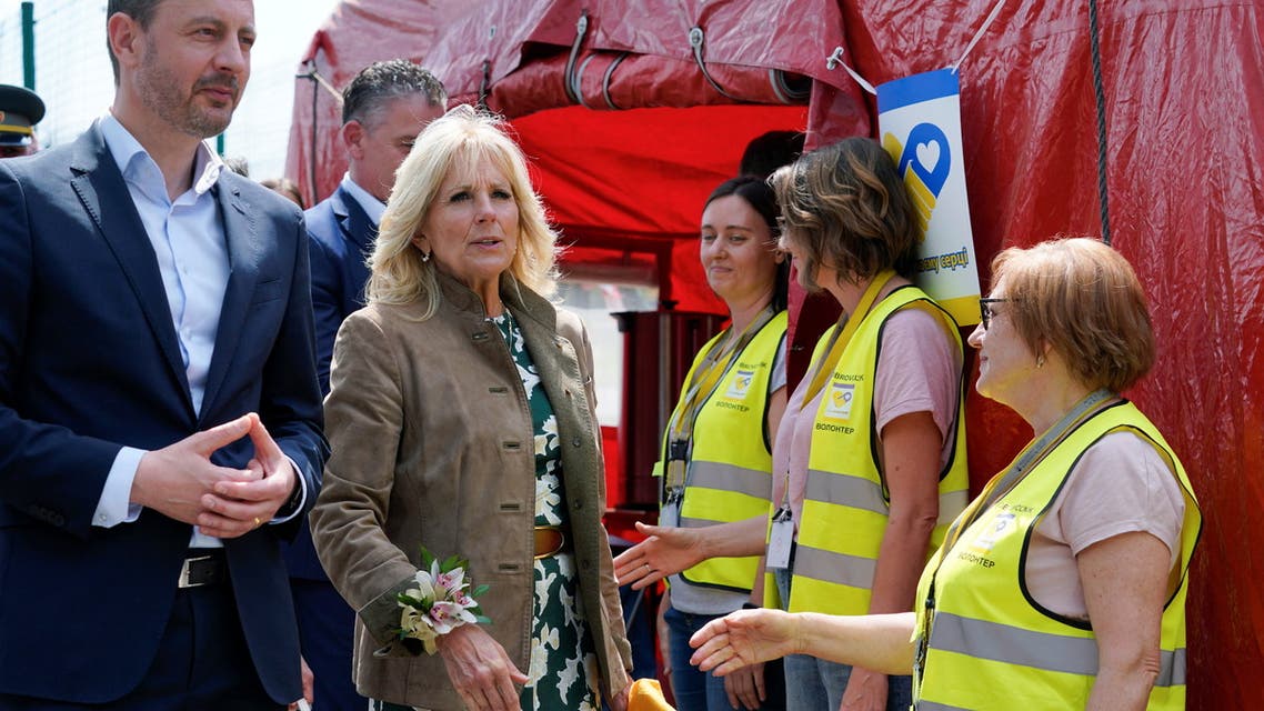 US first lady Jill Biden speaks with Slovakia's Prime Minister Eduard Heger as they meet volunteers in Vysne Nemecke, Slovakia, May 8, 2022. (Reuters)