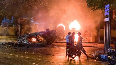 A vehicle belonging to the security personnel and a bus set alight is pictured near Sri Lanka's outgoing Prime Minister Mahinda Rajapaksa's official residence in Colombo May 9, 2022. (AFP)