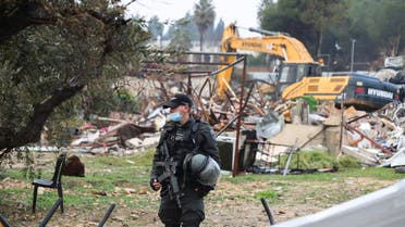A member of the Israeli border police stands guard at the site of a demolished house in the Sheikh Jarrah neighbourhood of East Jerusalem January 19, 2022. (Reuters)