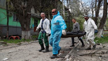 Funeral workers carry the body of a person killed during Ukraine-Russia conflict in the southern port city of Mariupol, Ukraine April 28, 2022. Picture taken April 28, 2022. REUTERS/Alexander Ermochenko