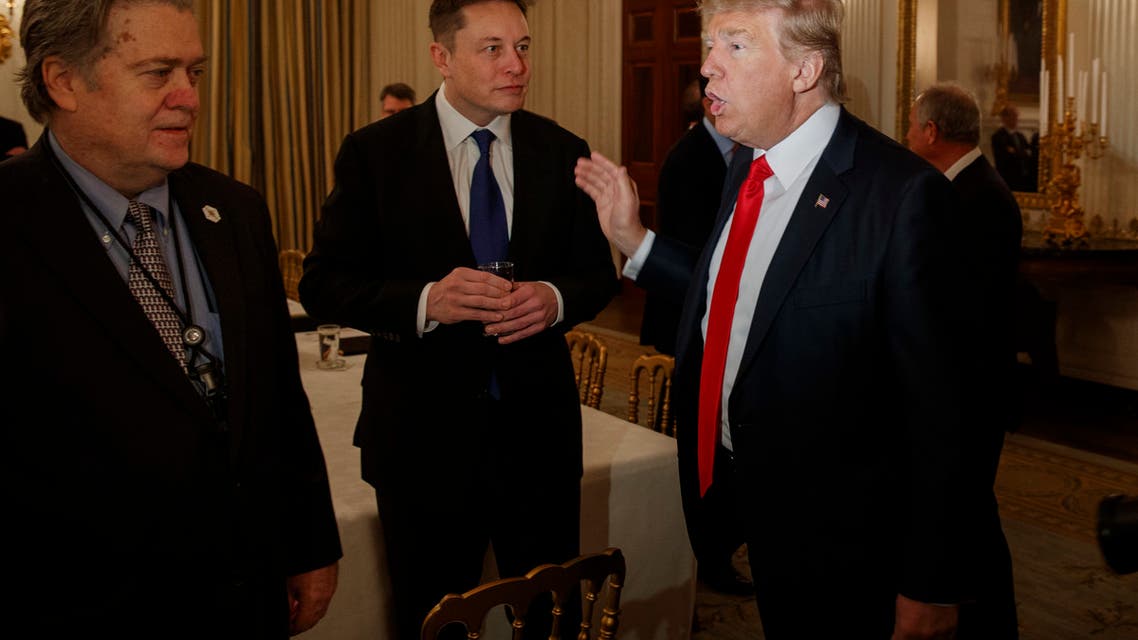 President Donald Trump talks with Tesla and SpaceX CEO Elon Musk, center, and White House chief strategist Steve Bannon during a meeting with business leaders in the State Dining Room of the White House in Washington, Friday, Feb. 3, 2017. (AP Photo/Evan Vucci)