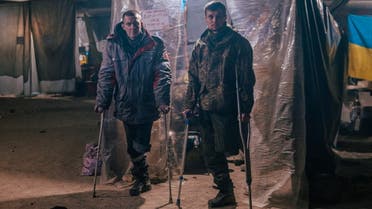 Injured Ukrainian service members use crutches at a field hospital inside a bunker of the Azovstal Iron and Steel Works in Mariupol, Ukraine, in this handout picture released May 10, 2022. (Reuters)