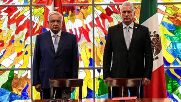 Cuban President Miguel Diaz Canel (R) and his Mexican counterpart Andrés Manuel López Obrador (L) arrive to sign bilateral agreements at the Revolution Palace in Havana, on May 8, 2022. (AFP)
