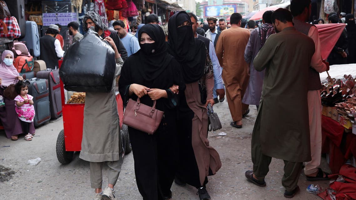 Afghan women walk at a market place in Kabul, Afghanistan, May 10, 2022. REUTERS/Ali Khara