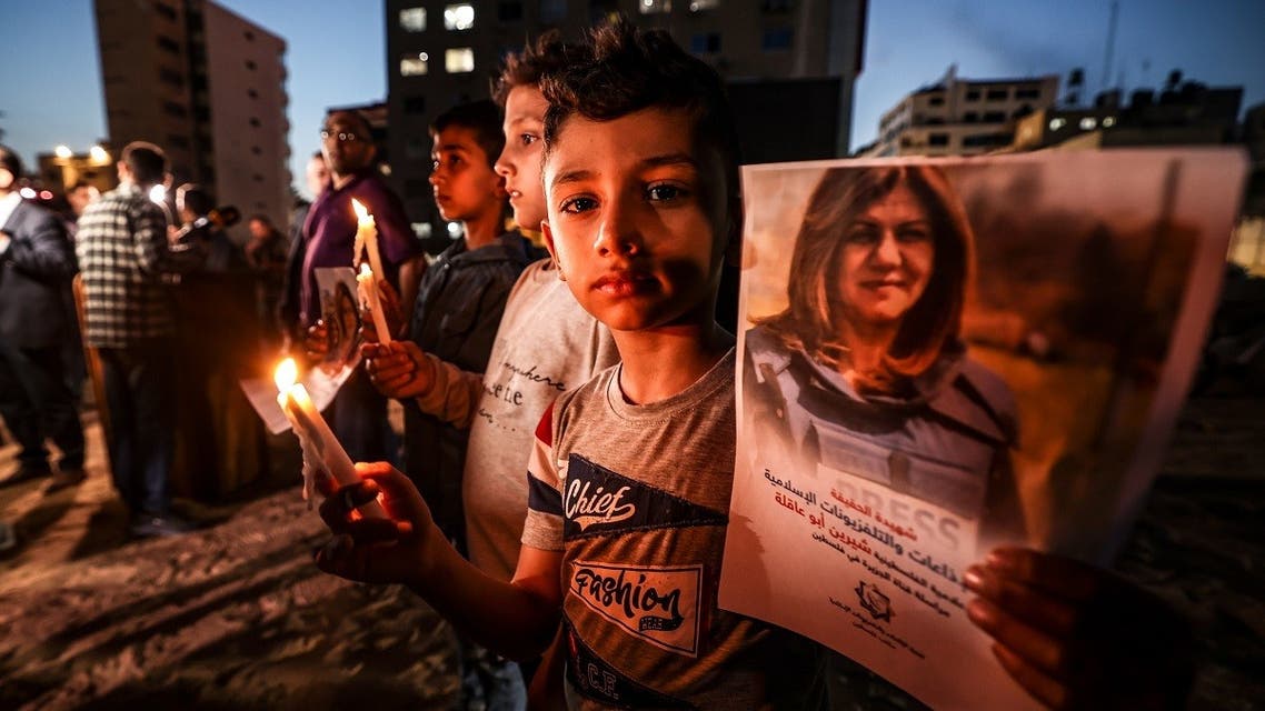 Children take part in a candlelight vigil to condemn the killing of Shireen Abu Akleh, in Gaza City, May 11, 2022. (AFP)