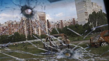 Burnt cars are pictured through the glass of a damaged car in Saltivka neighbourhood, amid Russia's attack on Ukraine, in Kharkiv, Ukraine, May 10, 2022. (Reuters)