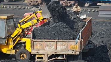 A worker sits on a truck being loaded with coal at a railway coal yard on the outskirts of the western Indian city of Ahmedabad November 25, 2013. (File photo: Reuters)