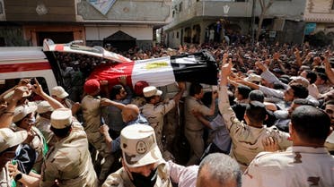 Mourners and soldiers carry the coffin containing the body of Egyptian officer Soleman Ali Soleman, who was killed in an armed attack claimed by Islamic State on Saturday in Egypt's Sinai peninsula, during a funeral at his home village Jazirat al-Ahrar, in Al Qalyubia Governorate, Egypt, May 9, 2022. (Reuters)